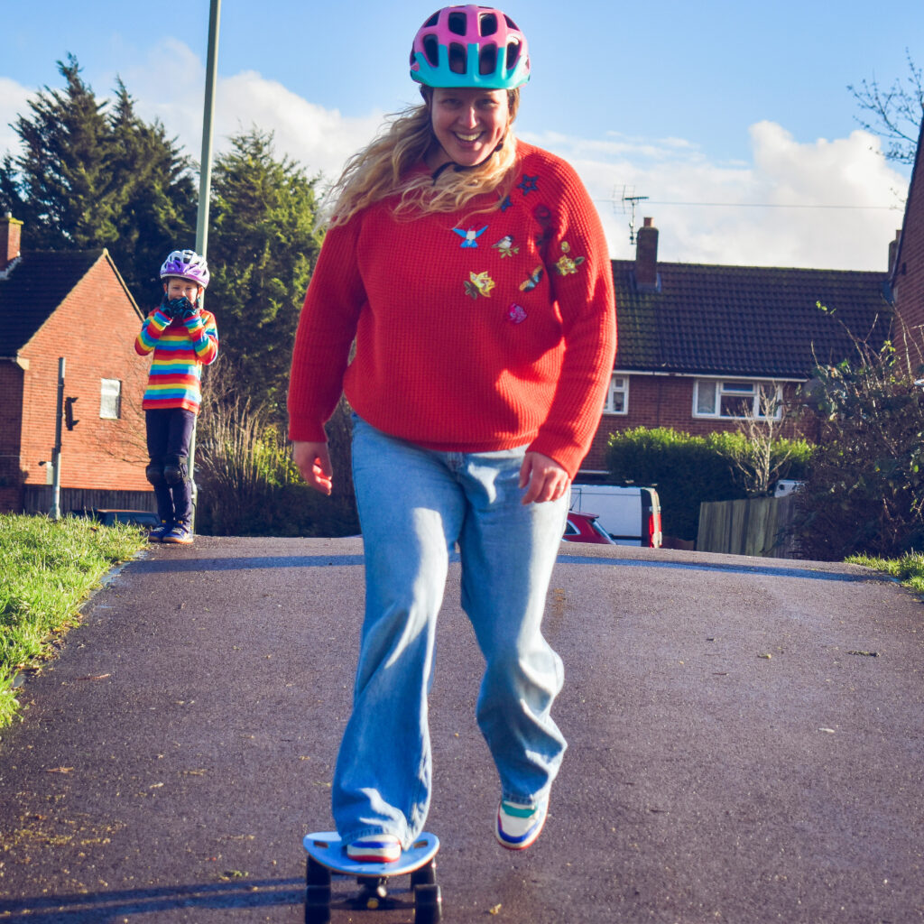 Play ideas: Photo of a woman riding a skateboard down a slope.
