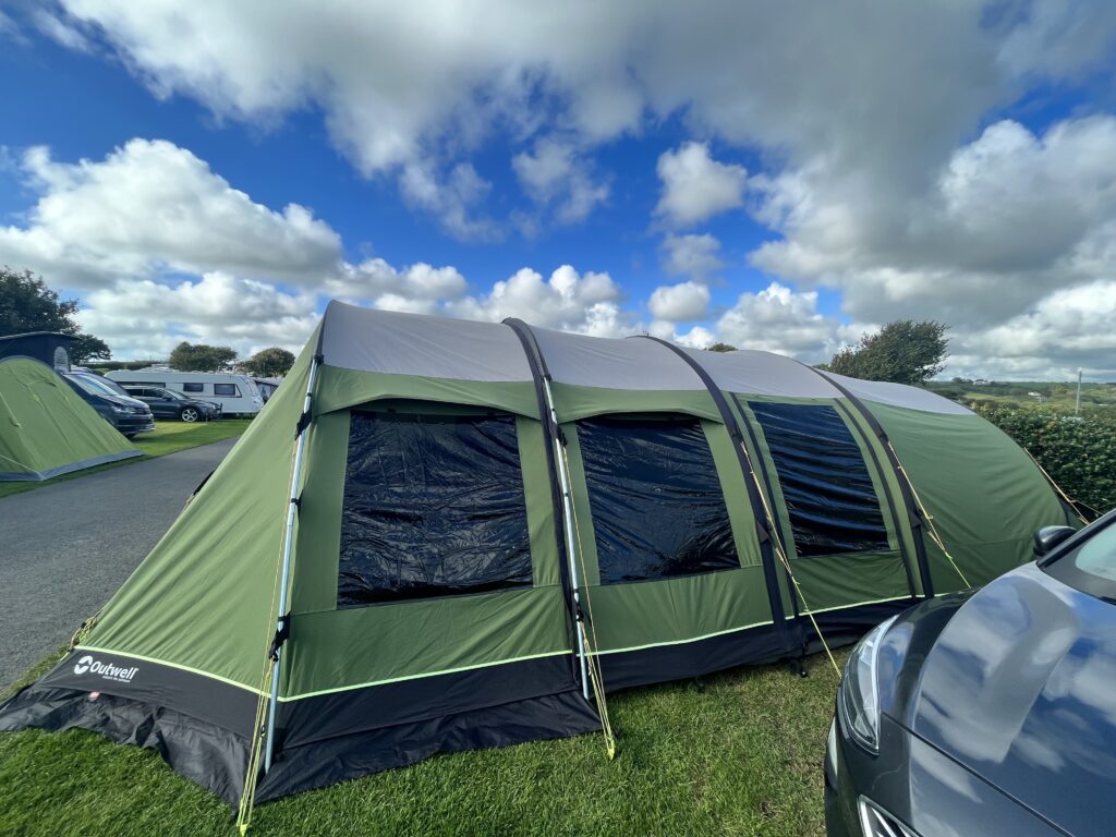First time camping essentials: Photo of a large green and grey tent.